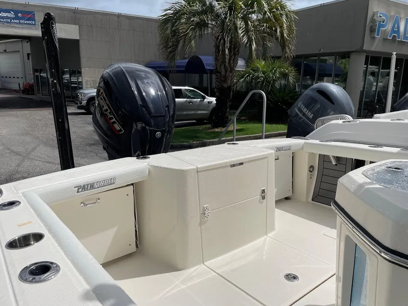 Slide: The Image of 2024 Pathfinder 2400 Open boat with dual outboard motors, docked near dealership. - 5