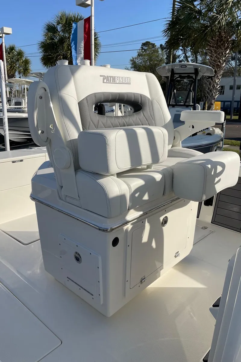 Slide: The Image of 2024 Pathfinder 2400 Open boat seat, white upholstery, outdoor setting. - 9