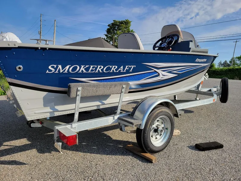 Slide: The Image of 2025 Smoker Craft 151 Resorter side console boat with Yamaha 25 hp engine on trailer. - 4