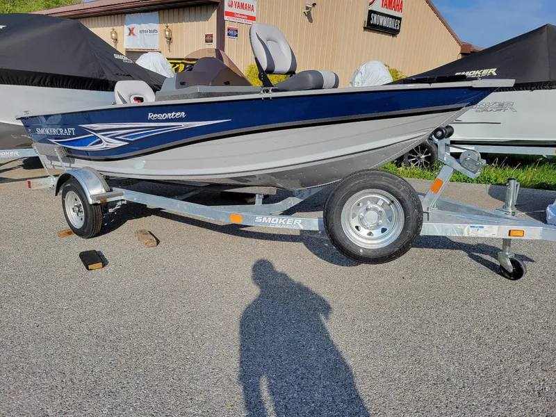 Slide: The Image of 2025 Smoker Craft 151 Resorter side console boat with Yamaha 25 hp engine on trailer. - 6