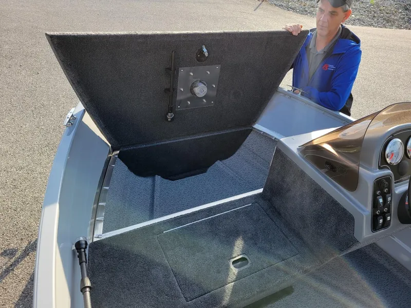 Slide: The Image of 2025 Smoker Craft 151 Resorter side console boat with open storage compartment. - 8