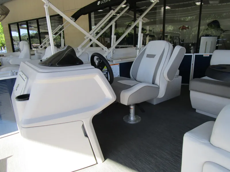 Slide: The Image of 2024 Sweetwater Xperience SW 2286 FX boat interior with captain's chair and steering console. - 3