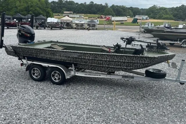 Slide: The Image of 2026 Custom 1860 Ultimate Panfish boat on trailer, parked on gravel lot. - 10