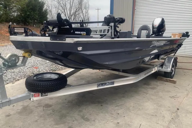 Slide: The Image of 2025 Custom 1860 Ultimate Panfish boat on trailer, equipped with Minn Kota motor. - 7