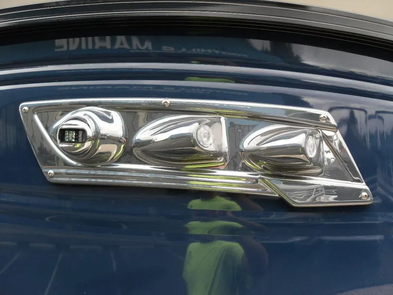 Slide: The Image of 2024 Regency 250 DL3 boat detail with chrome accents on a blue surface. - 12