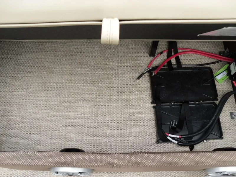 Slide: The Image of 2024 Regency 250 DL3 battery compartment with wiring and storage space. - 17