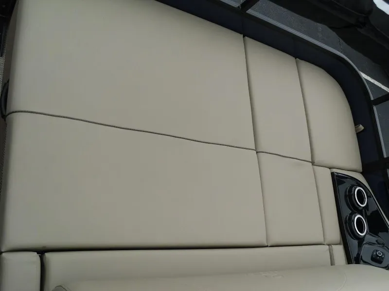 Slide: The Image of 2024 Regency 250 DL3 boat seating with beige upholstery and built-in cup holders. - 20