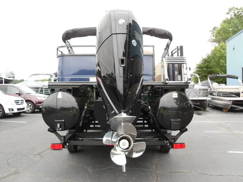 Slide: The Image of 2024 Regency 250 DL3 pontoon boat, rear view with powerful outboard motor. - 4