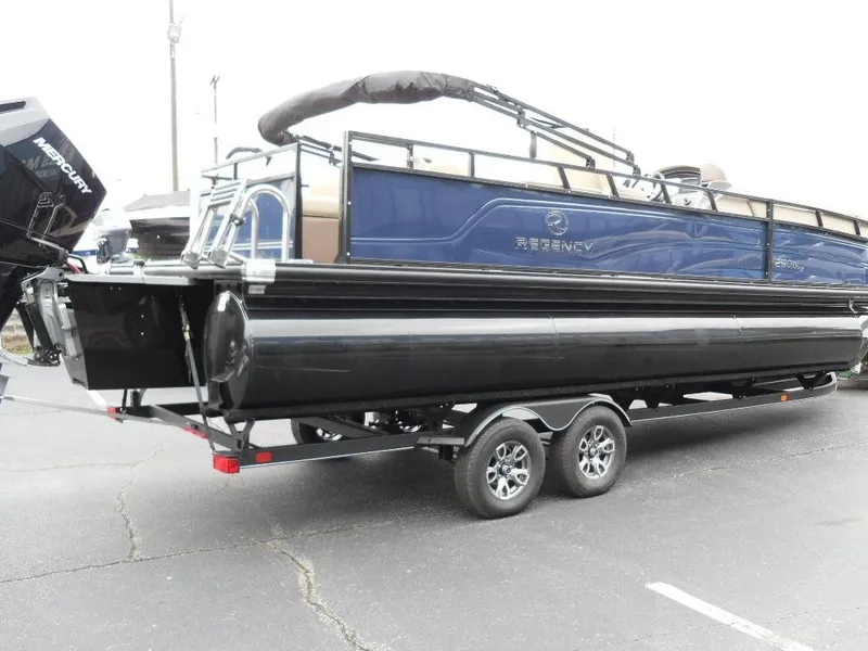Slide: The Image of 2024 Regency 250 DL3 pontoon boat on trailer, featuring sleek black and blue design. - 6