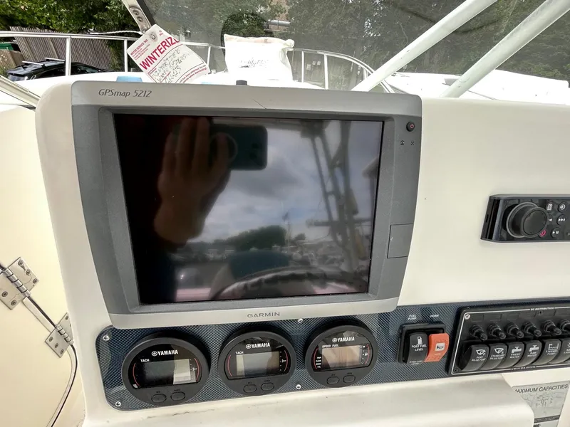Slide: The Image of 2007 World Cat 250 DC boat dashboard with Garmin GPSmap 5212 and control panel. - 6