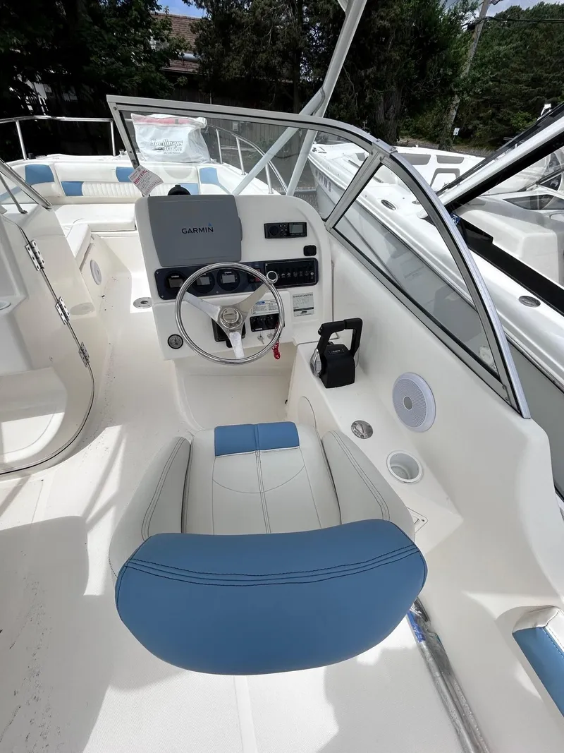 Slide: The Image of 2007 World Cat 250 DC boat interior with blue and white seating and steering console. - 7