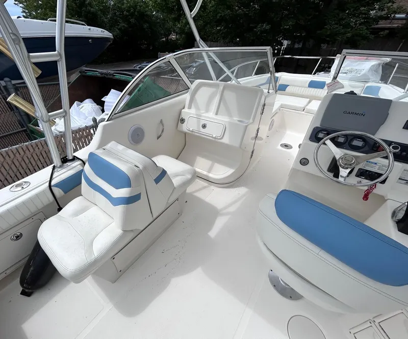 Slide: The Image of 2007 World Cat 250 DC boat interior with blue and white seating and steering console. - 8