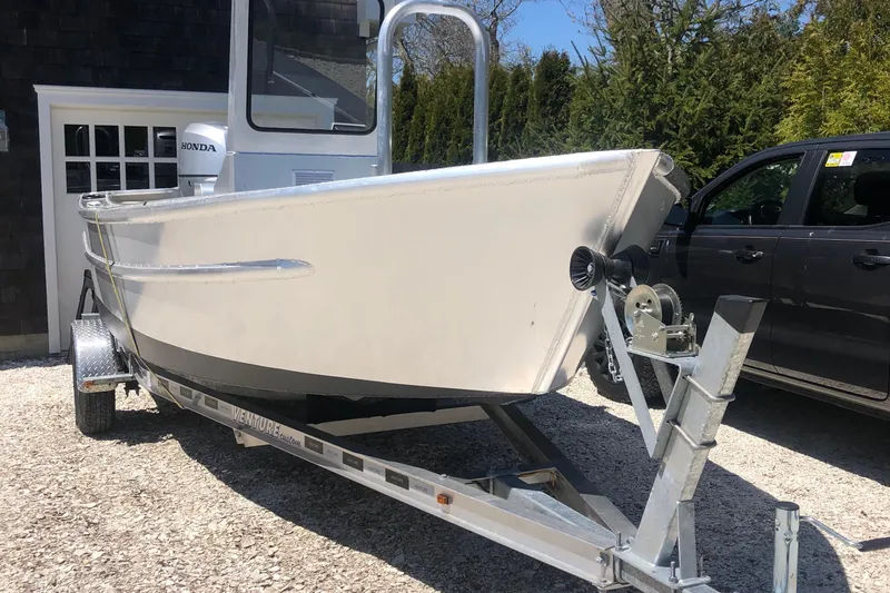 Slide: The Image of 2021 Custom 19 Center Console boat on trailer, parked outdoors. - 2