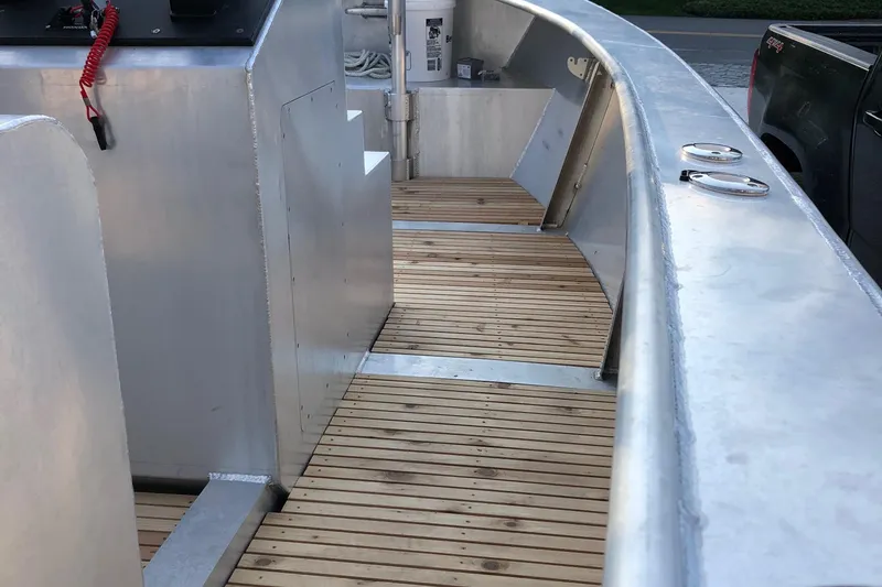 Slide: The Image of Custom 19 Center Console boat, 2021 model, featuring sleek aluminum and wood deck design. - 8