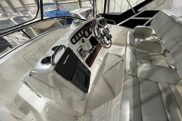 Slide: The Image of 2000 Silverton 392 Motor Yacht cockpit with steering wheel and control panel. - 10