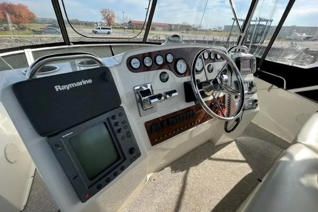 Slide: The Image of Helm of 2000 Silverton 392 Motor Yacht with Raymarine navigation system and classic controls. - 12