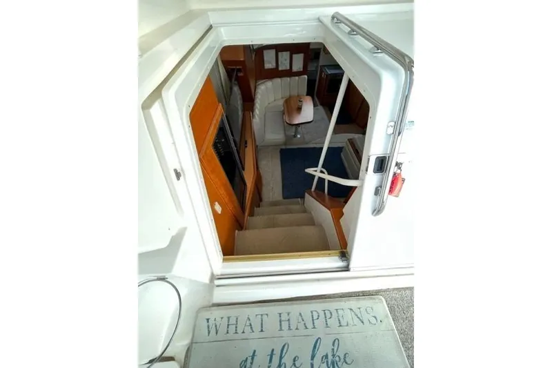 Slide: The Image of Interior view of 2000 Silverton 392 Motor Yacht, showing stairs and seating area. - 28