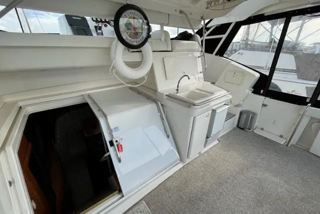 Slide: The Image of 2000 Silverton 392 Motor Yacht interior with sink, compass, and open hatch. - 20
