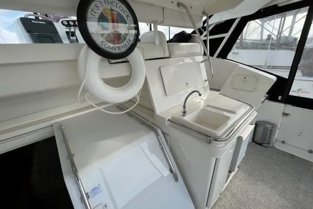 Slide: The Image of 2000 Silverton 392 Motor Yacht interior with sink, life preserver, and nautical decor. - 21