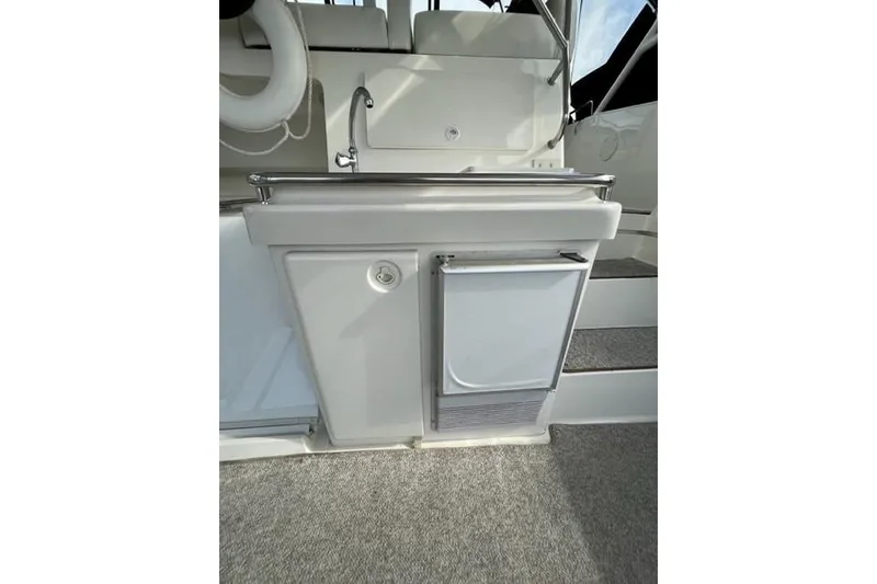 Slide: The Image of 2000 Silverton 392 Motor Yacht interior with sink and mini fridge. - 22