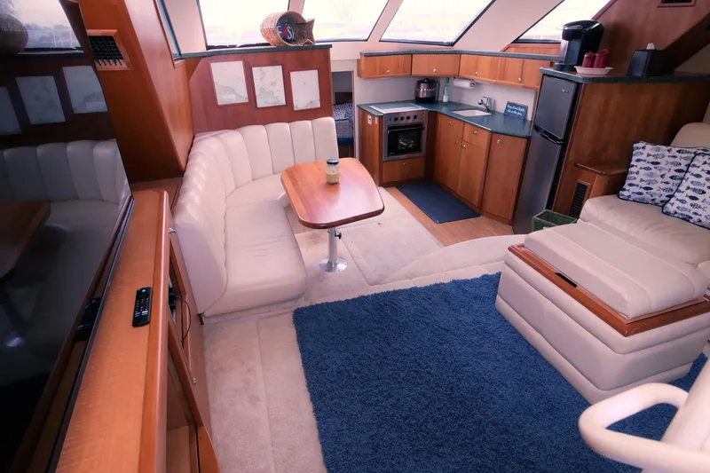 Slide: The Image of Luxurious interior of a 2000 Silverton 392 Motor Yacht with modern kitchen and seating area. - 29