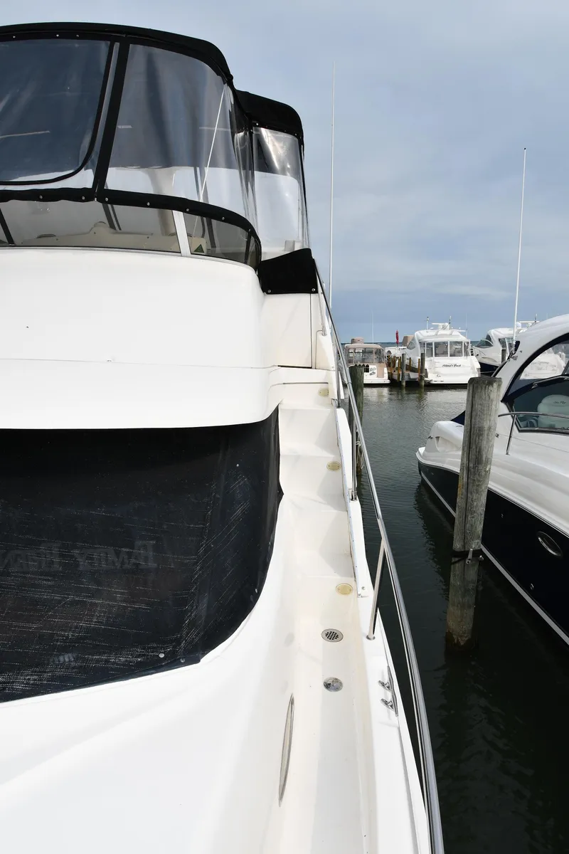 Slide: The Image of 2000 Silverton 392 Motor Yacht docked at marina. - 3