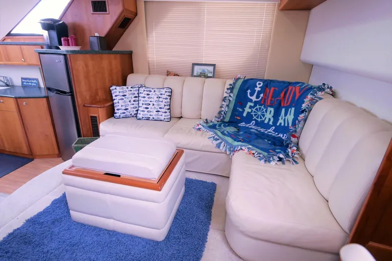 Slide: The Image of Interior of 2000 Silverton 392 Motor Yacht with cozy seating and nautical decor. - 32
