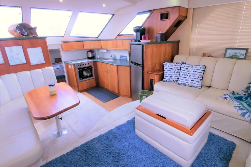 Slide: The Image of Interior of 2000 Silverton 392 Motor Yacht with cozy seating and modern kitchen amenities. - 33
