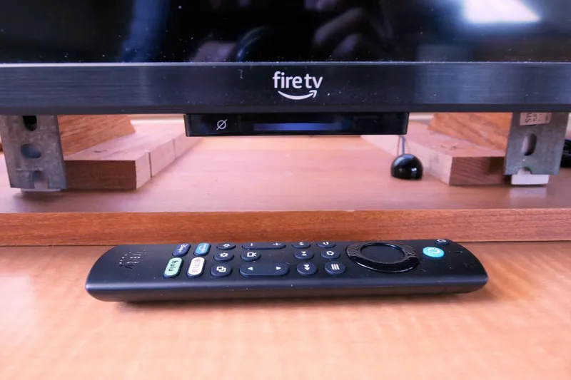 Slide: The Image of Fire TV setup with remote control on a wooden surface. - 35
