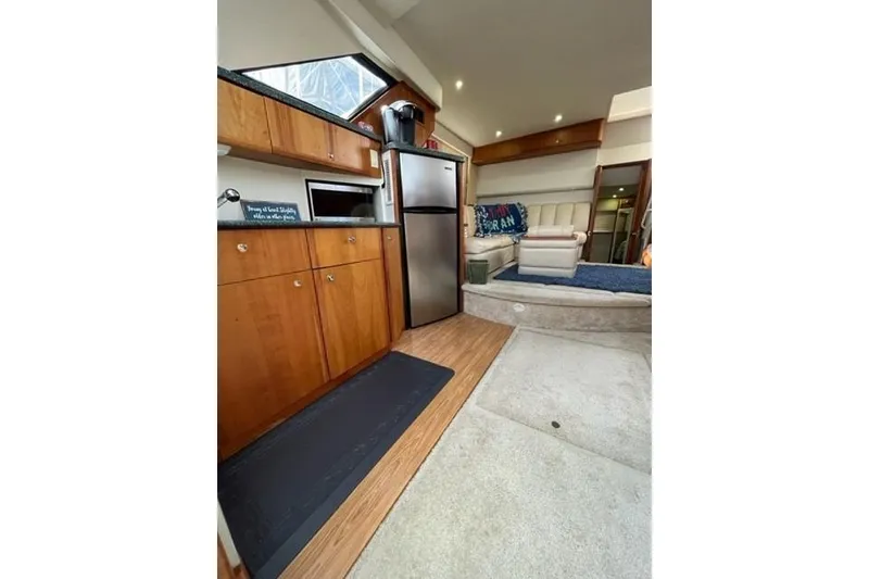 Slide: The Image of Interior of 2000 Silverton 392 Motor Yacht with kitchen and seating area. - 38