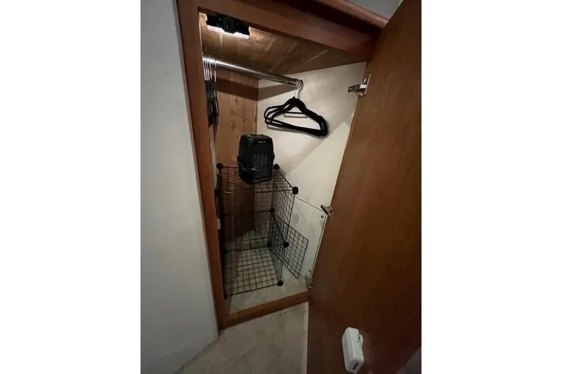 Slide: The Image of Closet interior on 2000 Silverton 392 Motor Yacht with hangers and storage. - 56