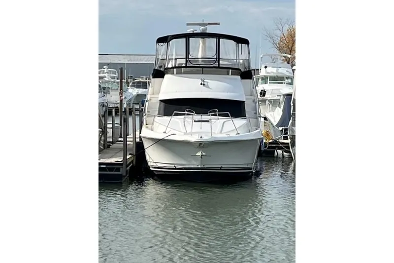Slide: The Image of 2000 Silverton 392 Motor Yacht docked at marina, front view. - 8