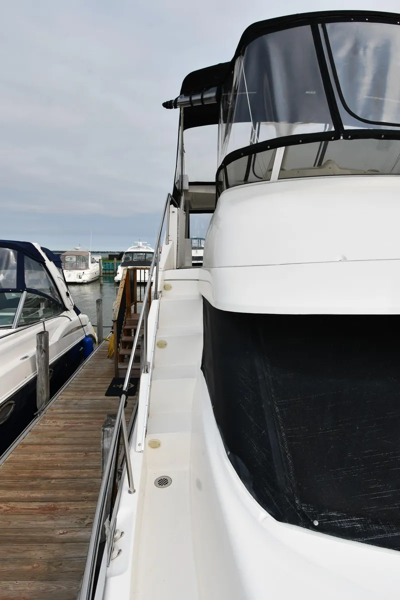 Slide: The Image of 2000 Silverton 392 Motor Yacht docked, side view. - 4