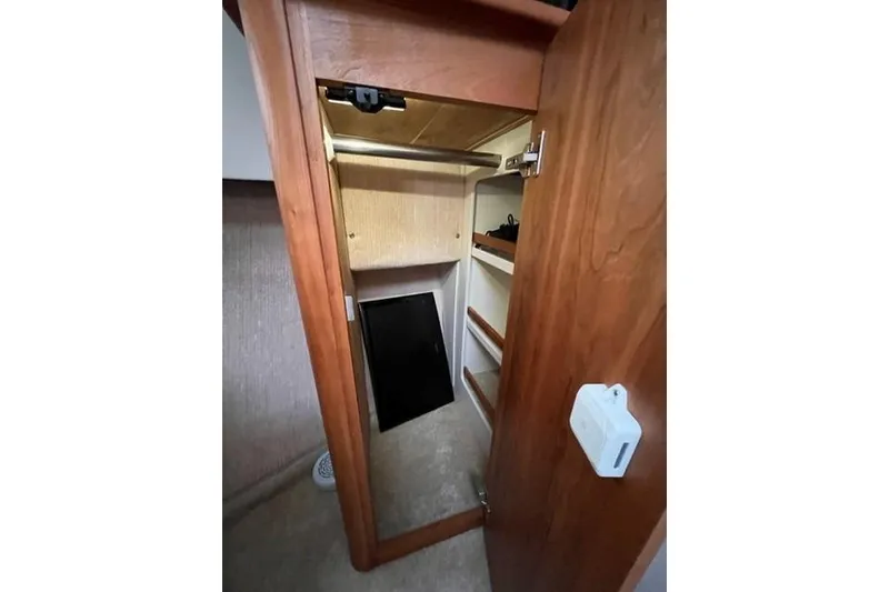 Slide: The Image of Interior closet of 2000 Silverton 392 Motor Yacht with wooden door and shelves. - 40