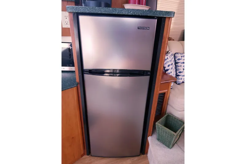 Slide: The Image of Stainless steel refrigerator inside a 2000 Silverton 392 Motor Yacht cabin. - 42