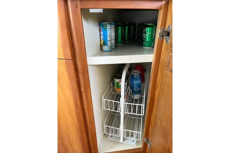 Slide: The Image of Cabinet storage with canned drinks on a 2000 Silverton 392 Motor Yacht. - 48
