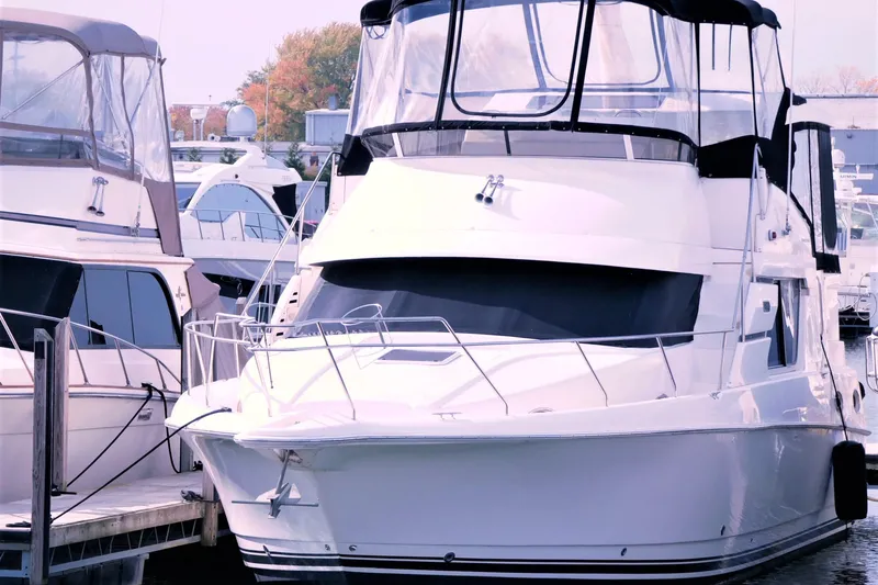 Slide: The Image of 2000 Silverton 392 Motor Yacht docked at marina, surrounded by other boats. - 5