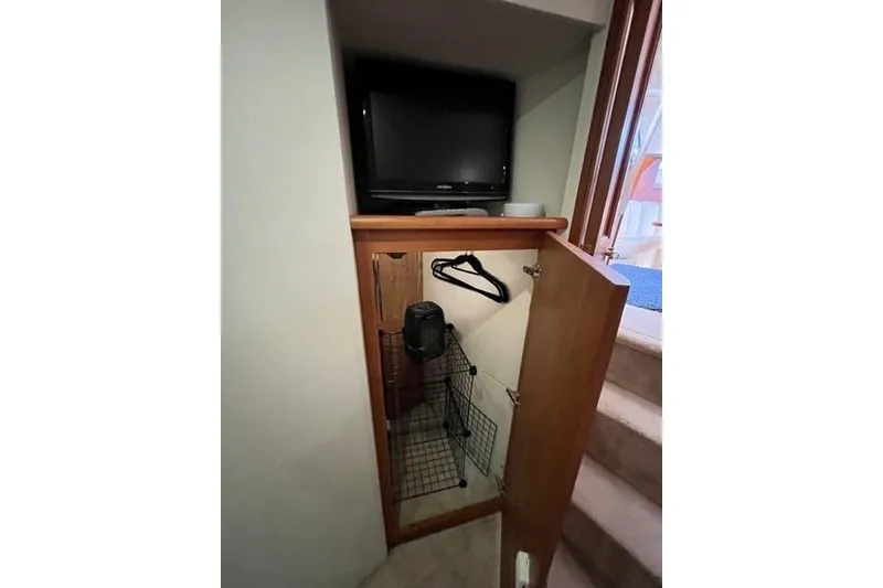 Slide: The Image of Interior of 2000 Silverton 392 Motor Yacht with TV and storage cabinet. - 57