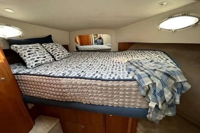 Slide: The Image of Cozy bedroom in 2000 Silverton 392 Motor Yacht with nautical-themed bedding. - 58