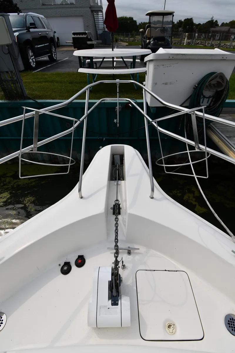 Slide: The Image of Bow view of 2000 Silverton 392 Motor Yacht in harbor. - 6