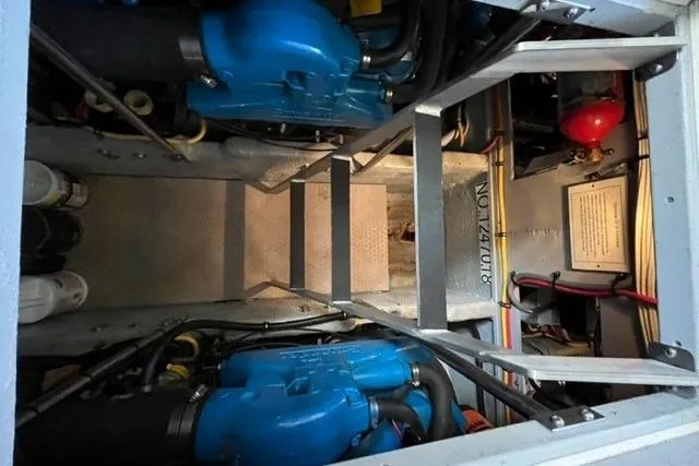 Slide: The Image of Engine room of a 2000 Silverton 392 Motor Yacht with visible blue engines. - 63