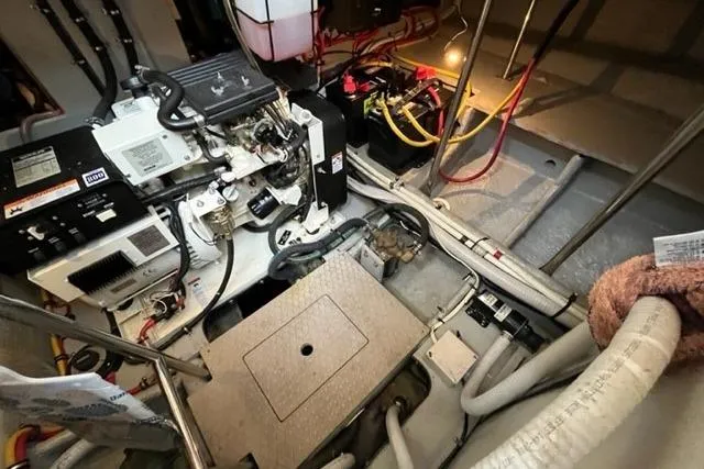 Slide: The Image of Engine room of a 2000 Silverton 392 Motor Yacht, showcasing mechanical components and wiring. - 65