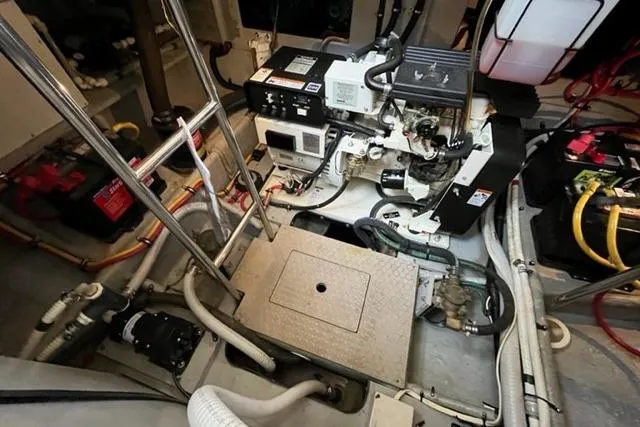 Slide: The Image of Engine room of a 2000 Silverton 392 Motor Yacht, showcasing mechanical components and wiring. - 66
