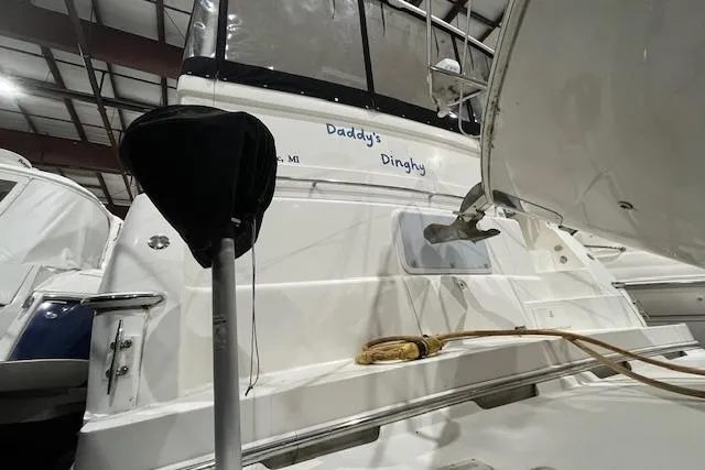 Slide: The Image of 2000 Silverton 392 Motor Yacht in storage, featuring "Daddy's Dinghy" name on the stern. - 9