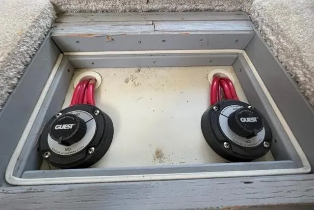 Slide: The Image of Battery switches on a 2000 Silverton 392 Motor Yacht, featuring red cables and "Guest" branding. - 73