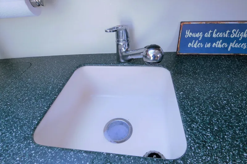 Slide: The Image of Sink and faucet on Silverton 392 Motor Yacht, 2000 model, with decorative sign. - 44