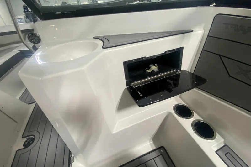 Slide: The Image of 2026 Starcraft SVX 210 boat interior with storage compartment and cup holders. - 25