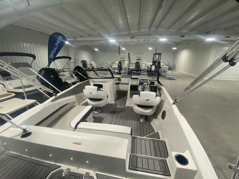 Slide: The Image of 2026 Starcraft SVX 210 boat interior in showroom, featuring modern seating and controls. - 5