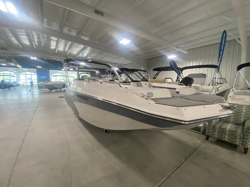 Slide: The Image of 2026 Starcraft SVX 210 boat displayed in a spacious indoor showroom. - 12