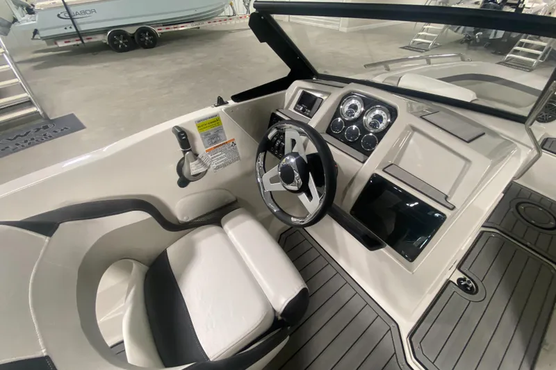 Slide: The Image of 2026 Starcraft SVX 210 boat interior with steering wheel and dashboard controls. - 21